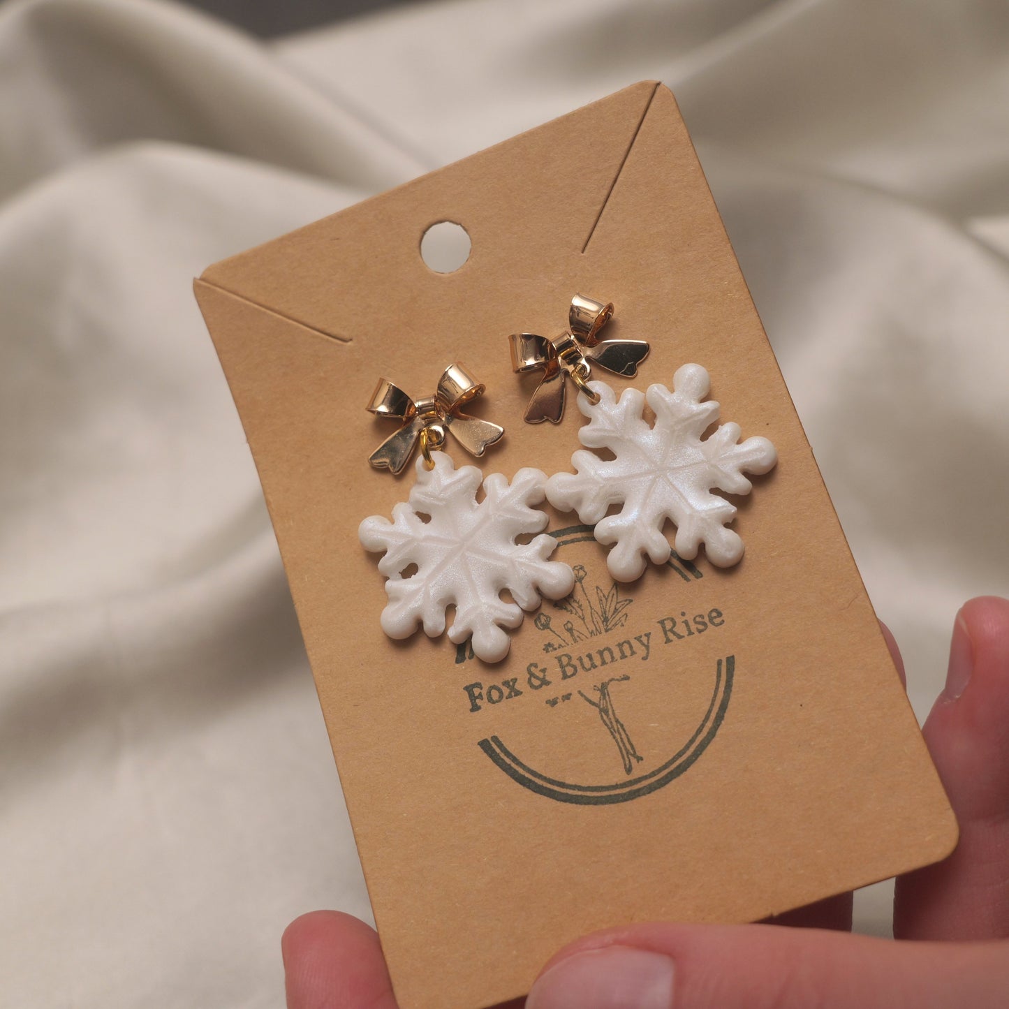 Iridescent Snowflakes with Gold Bows Dangle Earrings