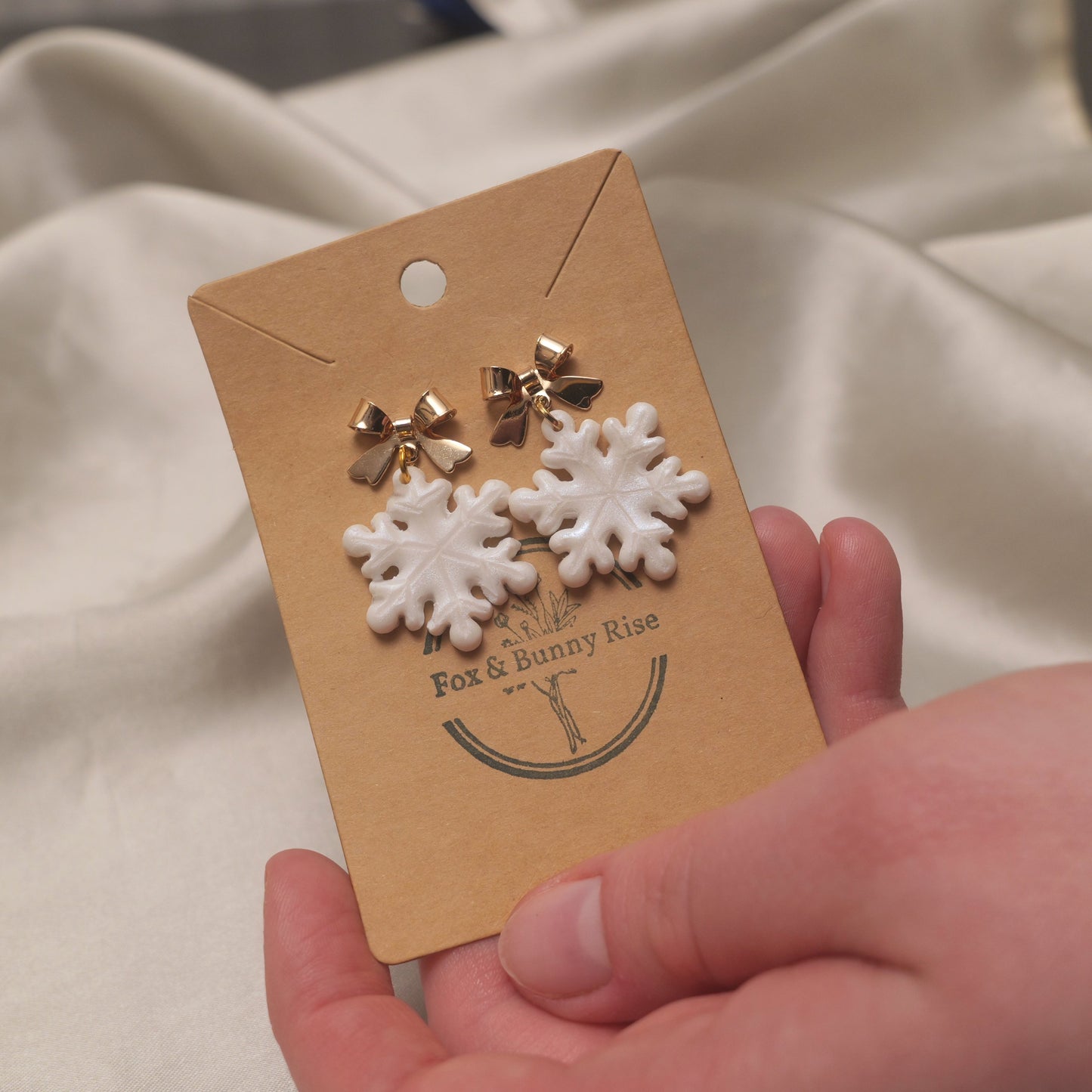 Iridescent Snowflakes with Gold Bows Dangle Earrings